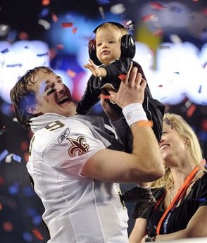 Saints' quarterback Drew Brees with his son